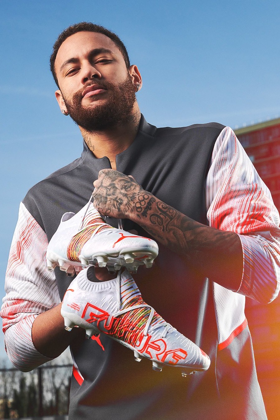 Ronaldo holds a red and black cleat